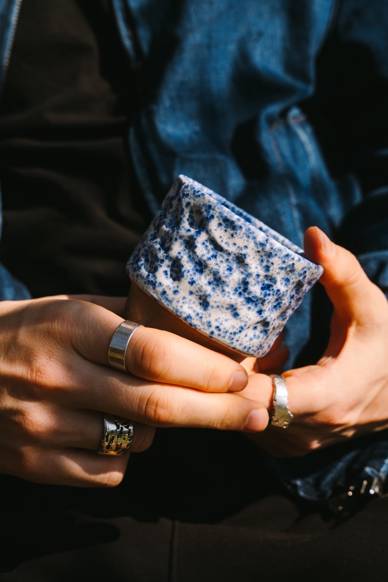 NOA ceramic coffee cup in close-up on a calm surface